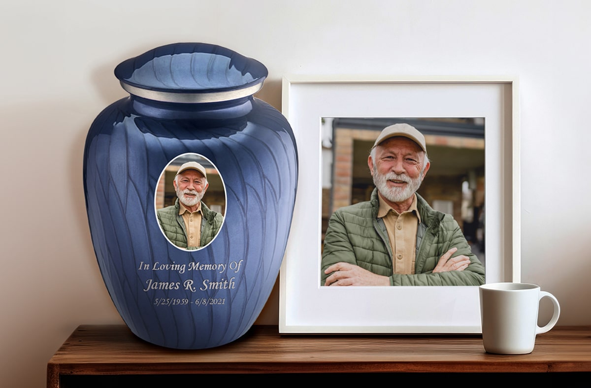 Picture Printed Urn with a photo frame & a cup placed on a table top